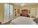 Bedroom with a ceiling fan, closet, and large window with white curtains at 4811 Summertree Rd, Venice, FL 34293