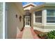 View of the front entrance with a screen door and covered walkway providing curb appeal at 4811 Summertree Rd, Venice, FL 34293