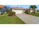 Charming home featuring a two-car garage, well-maintained lawn, and tasteful landscaping enhancing curb appeal at 4811 Summertree Rd, Venice, FL 34293