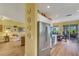 Open-concept kitchen with stainless steel refrigerator, breakfast nook, and access to outdoor space at 4811 Summertree Rd, Venice, FL 34293