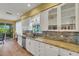 Well-lit kitchen featuring granite countertops, stainless steel appliances, and wood flooring at 4811 Summertree Rd, Venice, FL 34293