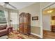 Living room featuring a vintage wardrobe, comfortable seating, and natural light from the windows at 4811 Summertree Rd, Venice, FL 34293