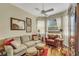Cozy living room with comfortable seating, decorative rug, and natural light from the windows at 4811 Summertree Rd, Venice, FL 34293