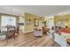 Open-concept living space with natural light, wood floors, and a combination dining area and kitchen at 4811 Summertree Rd, Venice, FL 34293