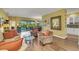 Open-concept living room featuring wood floors, a sliding glass door, and lots of space at 4811 Summertree Rd, Venice, FL 34293