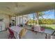 Screened patio with a table, chairs, lighting, and a ceiling fan at 4811 Summertree Rd, Venice, FL 34293