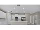 Open-concept kitchen featuring white cabinets and stainless steel appliances at 5 Debrita Rd, North Port, FL 34291
