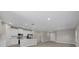 Open-concept kitchen and living space with recessed lighting and wood floors at 5 Debrita Rd, North Port, FL 34291