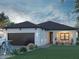 Charming single-story home with a two-car garage, inviting front porch, and well-maintained landscaping at 5 Varden Ter, North Port, FL 34288