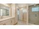 Elegant bathroom with dual vanity, marble countertops, modern finishes, and a frameless glass shower door at 512 Laurel Park Dr, Sarasota, FL 34236