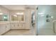 Large bathroom with dual sinks, marble countertops, modern finishes, and a frameless glass shower door at 512 Laurel Park Dr, Sarasota, FL 34236