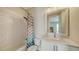 Bright bathroom features a tub and shower, white tiling, and a white granite countertop at 512 Laurel Park Dr, Sarasota, FL 34236