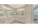 Spacious bathroom with dual vanity, big mirrors, modern lighting and tile flooring at 512 Laurel Park Dr, Sarasota, FL 34236