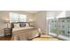 This bedroom features a full bed, light walls, a bedside table, and a sunny balcony at 512 Laurel Park Dr, Sarasota, FL 34236