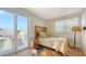 Cozy bedroom featuring a wooden accent headboard, balcony access, and a cowhide rug at 512 Laurel Park Dr, Sarasota, FL 34236