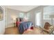 Cozy bedroom with modern decor, wood floors, and a sliding door to the outside at 512 Laurel Park Dr, Sarasota, FL 34236