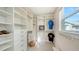 Well-organized walk-in closet with custom shelves, drawers, and hanging rods at 512 Laurel Park Dr, Sarasota, FL 34236