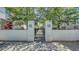 Entrance to Enclave at Laurel Park with pillars and landscaping at 512 Laurel Park Dr, Sarasota, FL 34236