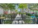 Exterior of townhomes with black fencing and tropical landscaping at 512 Laurel Park Dr, Sarasota, FL 34236