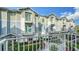 Townhome showcasing a charming exterior with balconies, complemented by manicured landscaping at 512 Laurel Park Dr, Sarasota, FL 34236