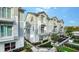 Multi-story townhomes feature stylish architecture with balconies, enhanced by lush greenery and landscaping at 512 Laurel Park Dr, Sarasota, FL 34236