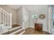 Bright and airy foyer with hardwood floors, stylish table, and staircase at 512 Laurel Park Dr, Sarasota, FL 34236