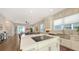Stylish open-concept kitchen with island cooktop, flowing into a living area with access to the outdoors at 512 Laurel Park Dr, Sarasota, FL 34236