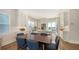 Bright kitchen and dining area featuring white cabinetry, stainless steel appliances, and a center island at 512 Laurel Park Dr, Sarasota, FL 34236