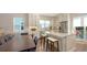 Modern kitchen with white cabinets, a stainless-steel refrigerator, and a view of the outdoor grill at 512 Laurel Park Dr, Sarasota, FL 34236