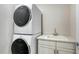 Laundry room featuring stacked white washer and dryer and bright sink at 512 Laurel Park Dr, Sarasota, FL 34236