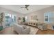 Inviting living room with hardwood floors, a modern ceiling fan and a sliding door to the balcony at 512 Laurel Park Dr, Sarasota, FL 34236