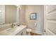 Elegant half-bathroom with stylish vanity, designer mirror, and modern fixtures at 512 Laurel Park Dr, Sarasota, FL 34236