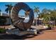 Public art on display in brick-laid pedestrian area near retail shops with the sun shining brightly and palm trees nearby at 512 Laurel Park Dr, Sarasota, FL 34236