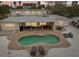 Aerial view of the backyard with a kidney-shaped pool, patio, and outdoor furniture at 55 N Washington Dr, Sarasota, FL 34236
