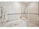 Bathroom with a bathtub with shower head and tiled walls at 55 N Washington Dr, Sarasota, FL 34236