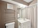 Cozy bathroom with vanity, shelving unit, and neutral-toned shower curtain for a relaxing space at 55 N Washington Dr, Sarasota, FL 34236