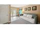 Relaxing bedroom featuring a daybed, calming art, and access to a private balcony at 55 N Washington Dr, Sarasota, FL 34236