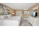 Comfortable bedroom with a queen-size bed, white dresser with TV, and closet with sliding doors at 55 N Washington Dr, Sarasota, FL 34236