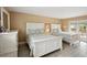 Bright bedroom featuring two beds, light gray floors, and access to the porch at 55 N Washington Dr, Sarasota, FL 34236