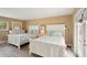 Bedroom featuring two beds, a dresser, and light tan walls at 55 N Washington Dr, Sarasota, FL 34236