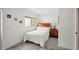 Cozy bedroom with wood headboard, white bedding, bedside table, and a neutral area rug at 55 N Washington Dr, Sarasota, FL 34236