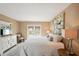 Comfortable bedroom with a queen-size bed, balcony access, and dresser with a mounted television at 55 N Washington Dr, Sarasota, FL 34236