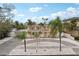 Charming two-story home with balconies, a circular driveway, and tropical landscaping at 55 N Washington Dr, Sarasota, FL 34236
