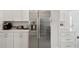 Kitchen area featuring stainless steel refrigerator, white cabinets, and marble countertops at 55 N Washington Dr, Sarasota, FL 34236