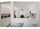 Open kitchen view featuring white cabinets, stainless steel appliances, and a breakfast nook at 55 N Washington Dr, Sarasota, FL 34236
