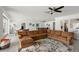 Bright and airy living room featuring a large sectional sofa, modern ceiling fan, and open layout at 55 N Washington Dr, Sarasota, FL 34236
