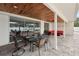 Covered outdoor patio featuring a dining area and lounge seating, perfect for entertaining at 55 N Washington Dr, Sarasota, FL 34236