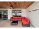 Outdoor seating area featuring outdoor carpet, a red couch, and wood ceiling at 55 N Washington Dr, Sarasota, FL 34236