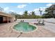 Backyard kidney shaped pool surrounded by white gravel and a paver patio featuring lounge seating at 55 N Washington Dr, Sarasota, FL 34236