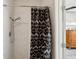 Shower with black and white patterned curtain, modern shower head, and white marble tiling at 55 N Washington Dr, Sarasota, FL 34236